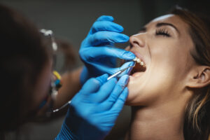 Beautiful young woman sitting at the dentist’s office for Dental Bonding in Broomfield.